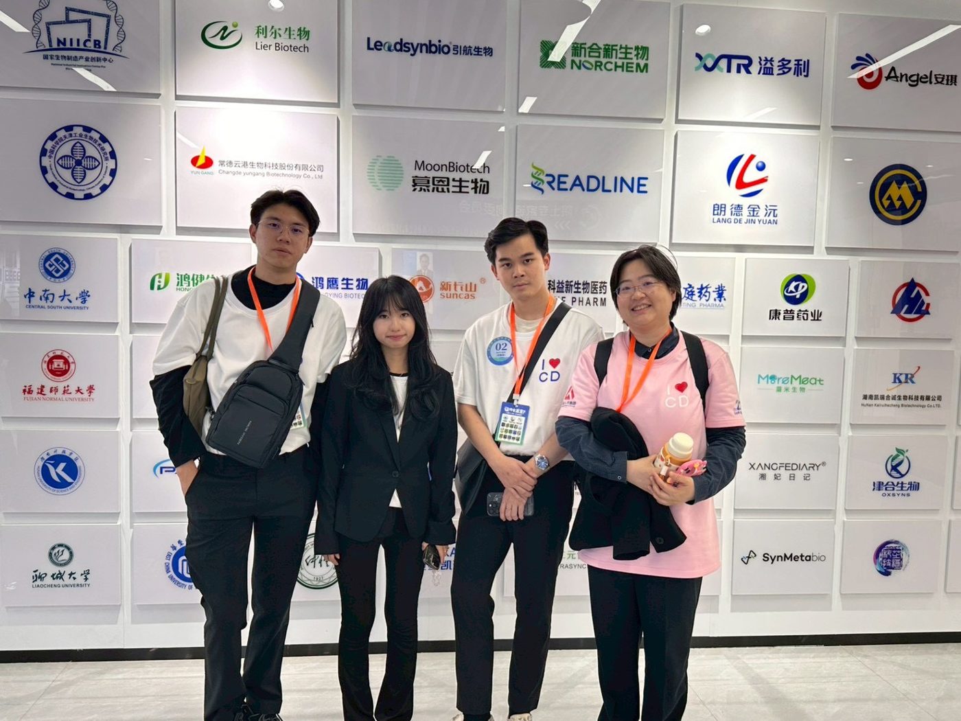 Team in front of the sponsor wall